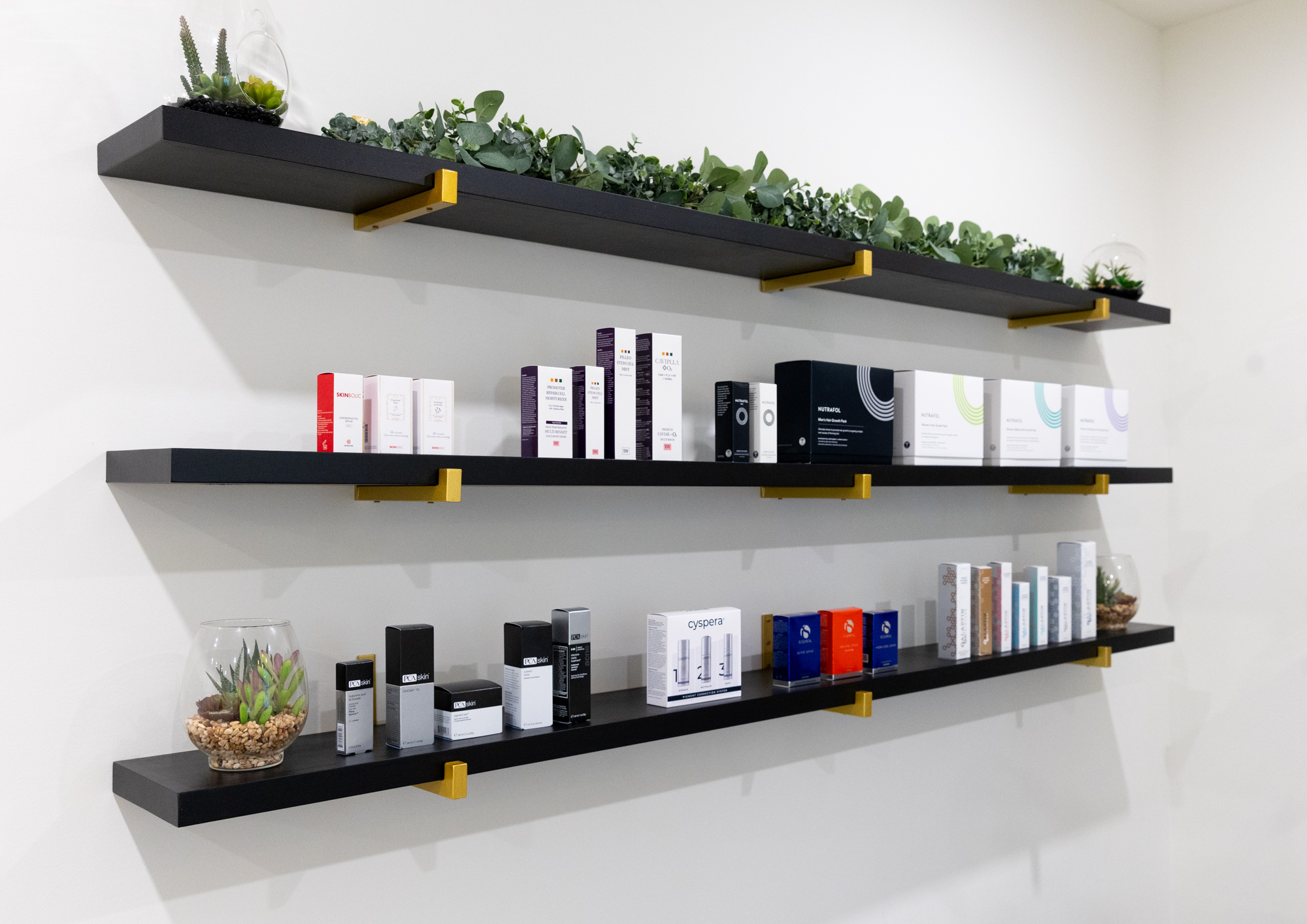 3 shelves containing a variety of skin care products