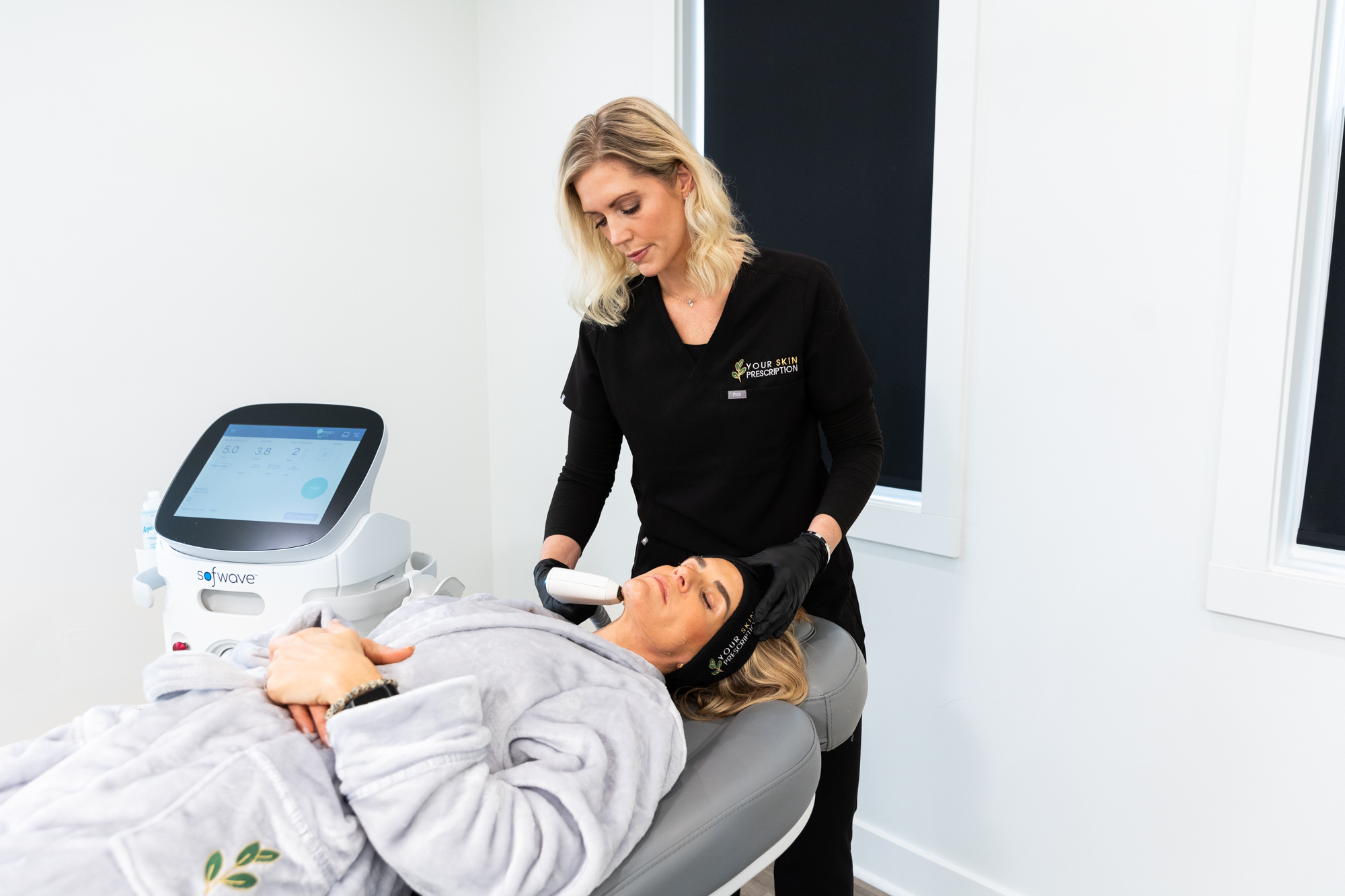 A female medical professional is performing a skin care treatment on a woman near Pittsburgh